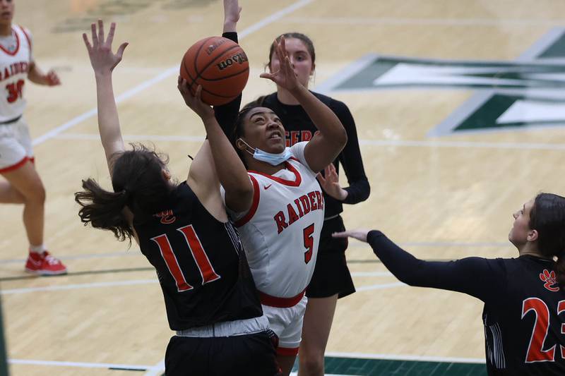 Bolingbrook’s Kennedi Perkins battles for a layup against Edwardsville in the Class 4A Illinois Wesleyan Super-sectional. Friday, Feb. 25, 2022, in Bloomington.