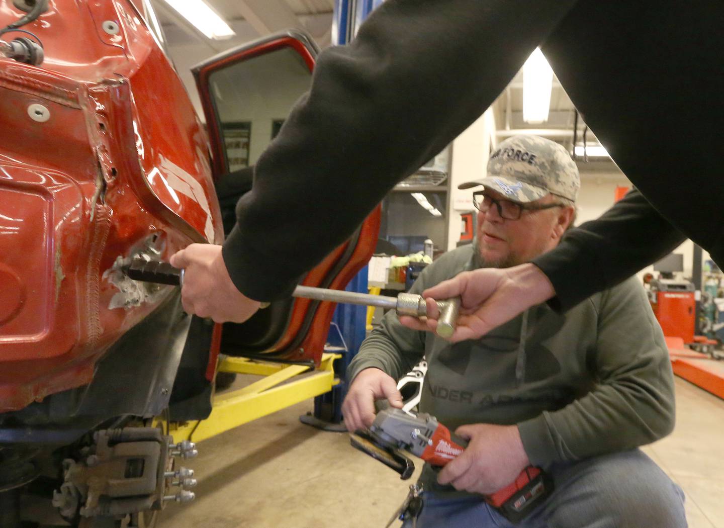 John Hladovack, auto mechanic instructor teaches students how to work on a vehicle on Monday, May 1, 2023 at Ottawa High School.