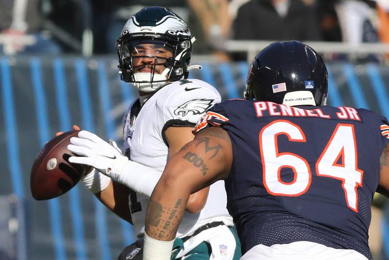 Philadelphia Eagles quarterback Jalen Hurts throws a pass just ahead of the pressure of Chicago Bears defensive tackle Mike Pennel Jr. during their game Sunday, Dec. 18, 2022, at Soldier Field in Chicago.