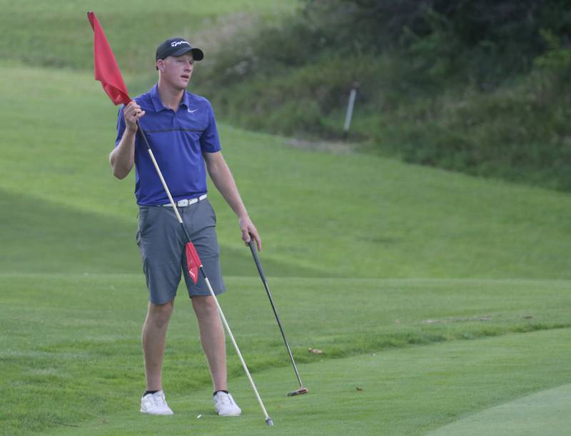 Ben Cyr removes the flag from the 17th hole during the Illinois Valley Mens Golf Championship Tournament on Sunday, July 27, 2025 at Spring Creek Golf Course in Spring Valley.