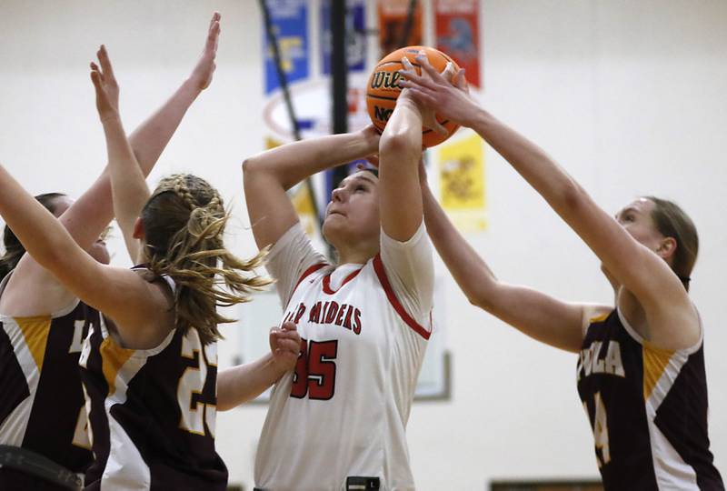 Huntley's Paula Strzelecki tries to get a shoot off as Loyola Academy's Emily Naraky grabs the ball during the IHSA Class 4A Gurnee Warren Supersectional girls basketball game on Monday, March 3, 2025, at Warren Township High School in Gurnee.