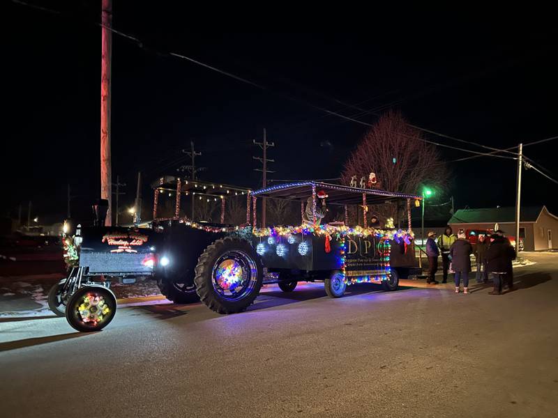 Light-adorned floats drive down Main Street in the 23rd annual Jingle Bell Parade during the Genoa Area Chamber of Commerce's annual Celebrate the Season holiday event on Dec. 6, 2024, in downtown Genoa.