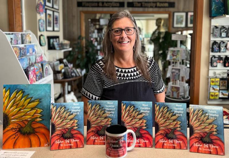Patty Donahue, owner of Image Awards, Engraving & Creative Keepsakes Inc. with awards and keepsake mug she created for the self-guided Jack-O’-Lantern Walk set in downtown Geneva Oct. 6. This will be the fifth anniversary of the event.