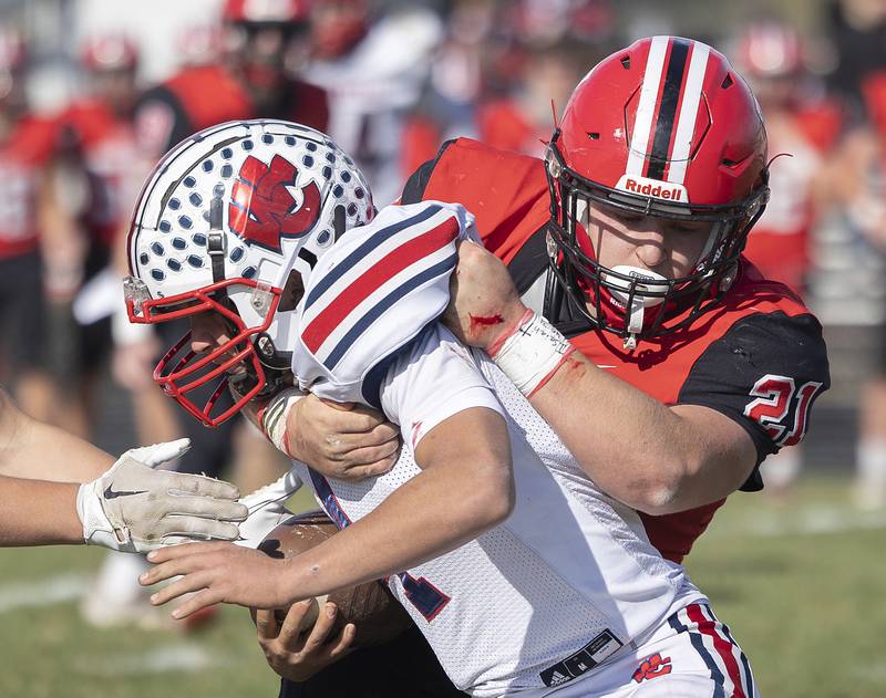 Amboy’s Quinn Leffelman hauls down West Central QB Gage Stimpson Saturday, Nov. 2, 2024, in the 8-man football league first round playoffs.