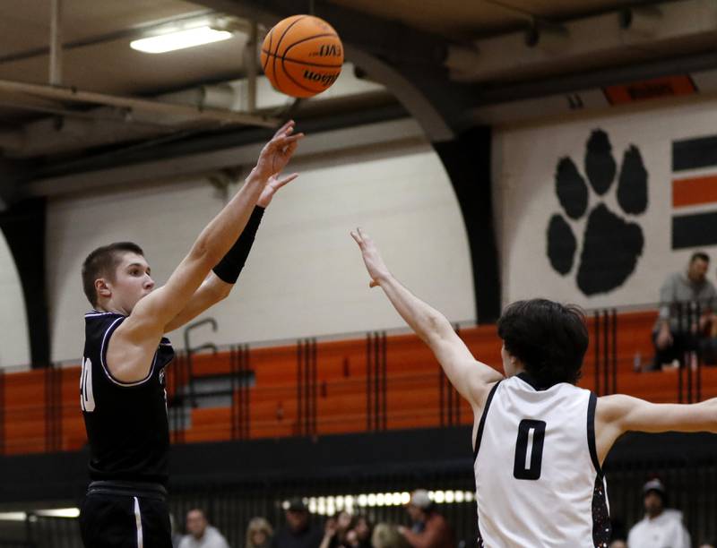 Hampshire's Ryan Prowicz shoots the ball over Crystal Lake Central's Jackson Hopkins during a Fox Valley Conference basketball game on Friday, Feb. 7, 2025, at Crystal Lake Central High School.