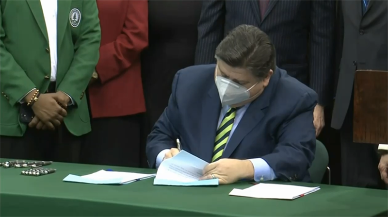 Gov. JB Pritzker sings the state's Fiscal Year 2023 operating budget at Chicago State University Tuesday.