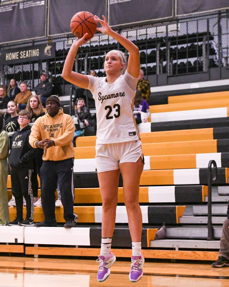 Sycamore Evyn Carrier (23) makes a three point shot during the first quarter while taking on Kaneland Thursday Feb. 2nd held at Sycamore High School.