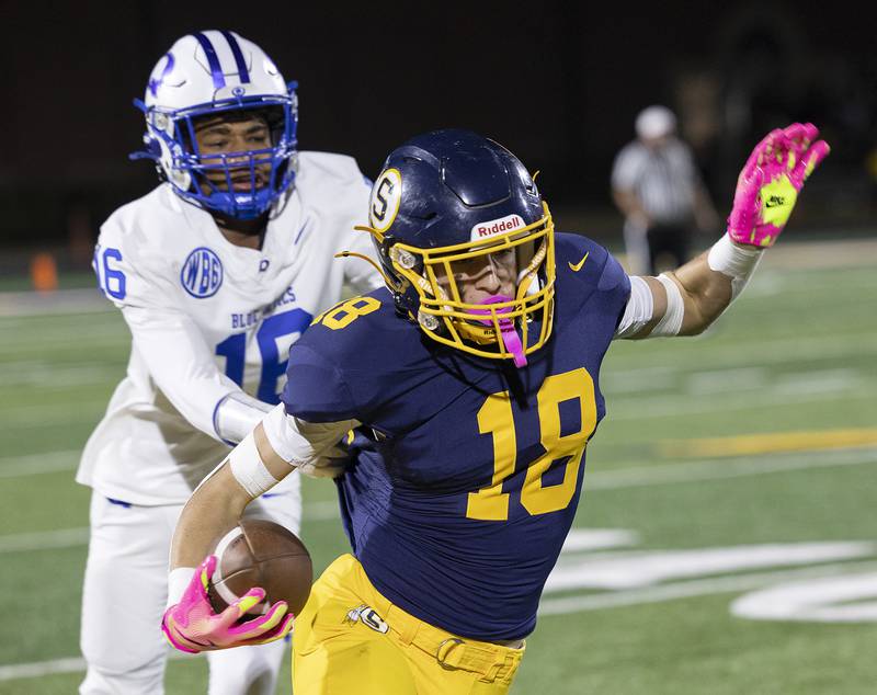 Sterling’s Koltyn Chapman is grabbed by Quincy’s Nasier Kelley Friday, Oct. 17, 2025.