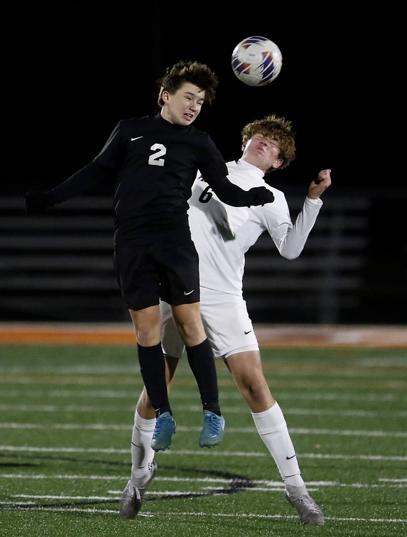 McHenry's Eli Wickenkamp heads the ball away from Prairie Ridge's Matthew Fireng during a Fox Valley Conference soccer match on Tuesday, Oct. 15, 2024, at McCraken Field in McHenry.