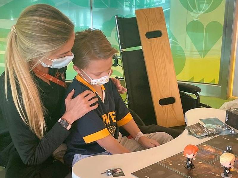 Eight-year-old Cooper Roberts, paralyzed in the July Fourth parade shooting in Highland Park, works on motor skills with an occupational therapist from the Shirley Ryan AbilityLab in Chicago.