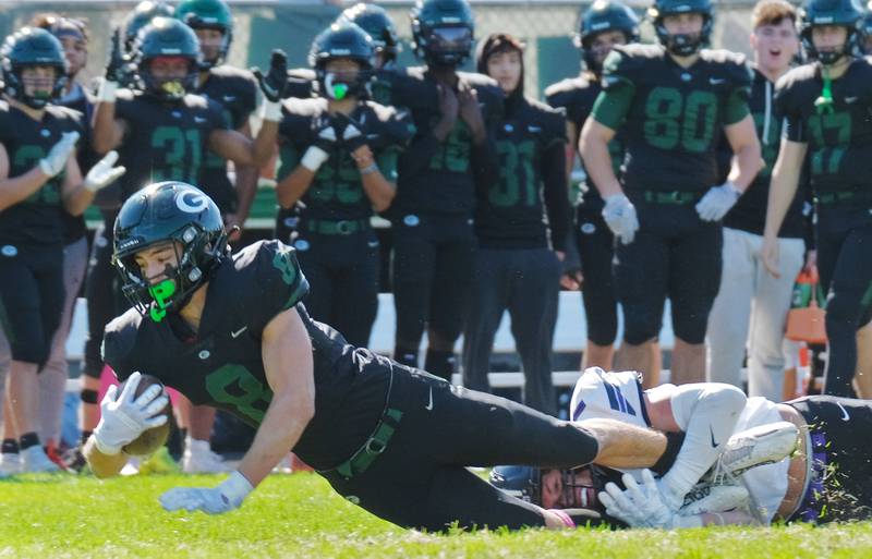Glenbard West's Filip Maciorowski (8) stretches for an extra yard after making a catch agains Downers Grove North during a game on Oct. 8, 2022 at Glenbard West High School in Glen Ellyn.