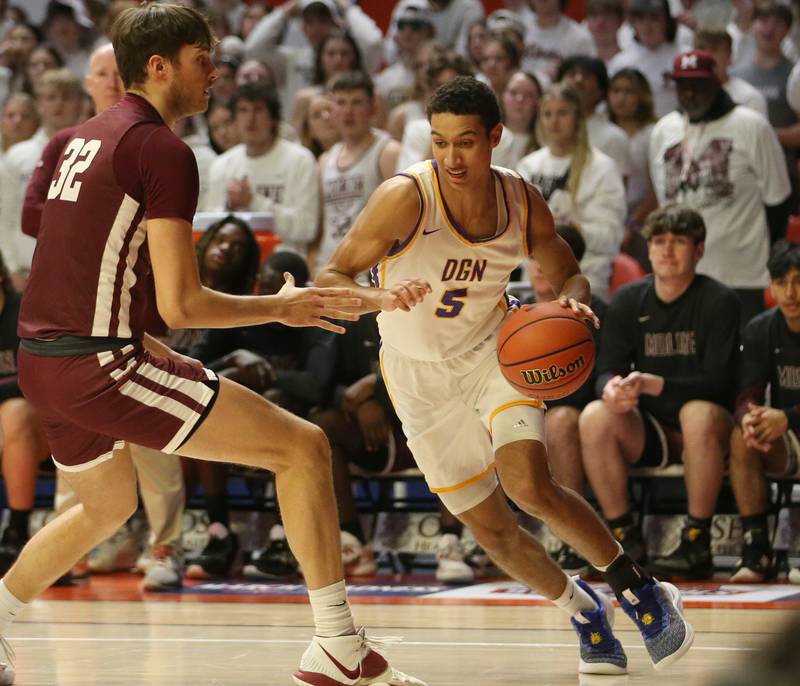 Downers Grove North's Jacob Bozeman dribbles around Moline's Owen Freeman during the Class 4A state semifinal game on Friday, March 10, 2023 in Champaign.