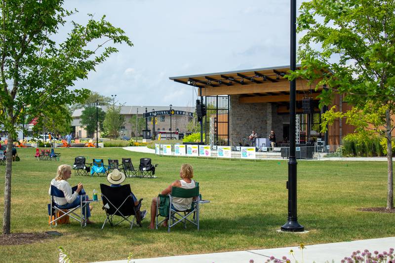 Attendees enjoy live music on the green during the 5th annual Bourbonnais Food Truck Festival on Saturday, Aug. 16, 2025, at The Grove in Bourbonnais.