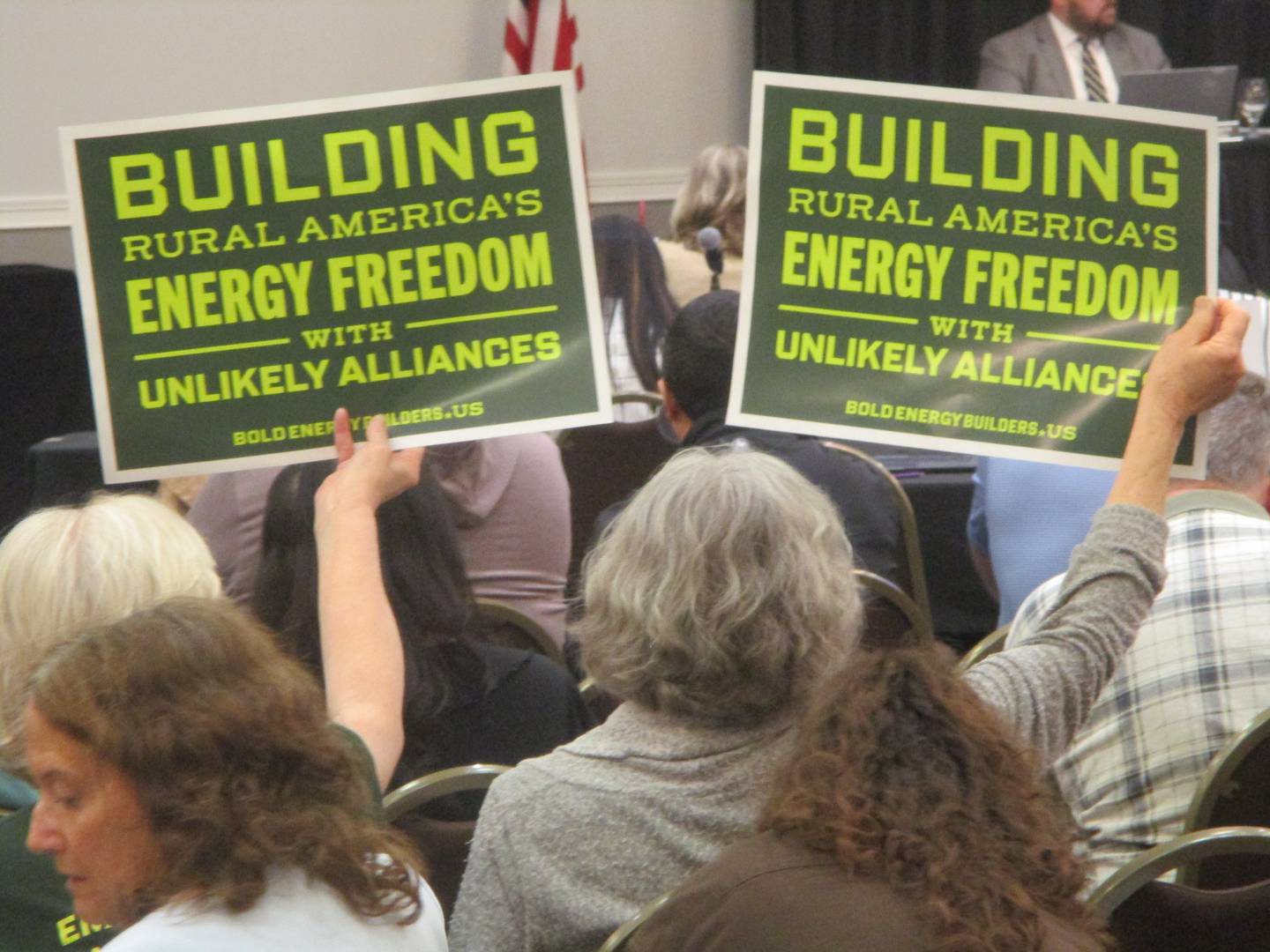 Solar energy supporters hold up signs Thursday at the Will County Board meeting in Joliet. April 16, 2026