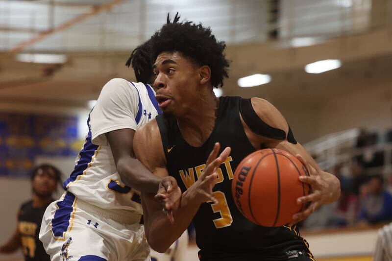 Joliet West’s Matthew Moore drives along the baseline against Joliet Central.