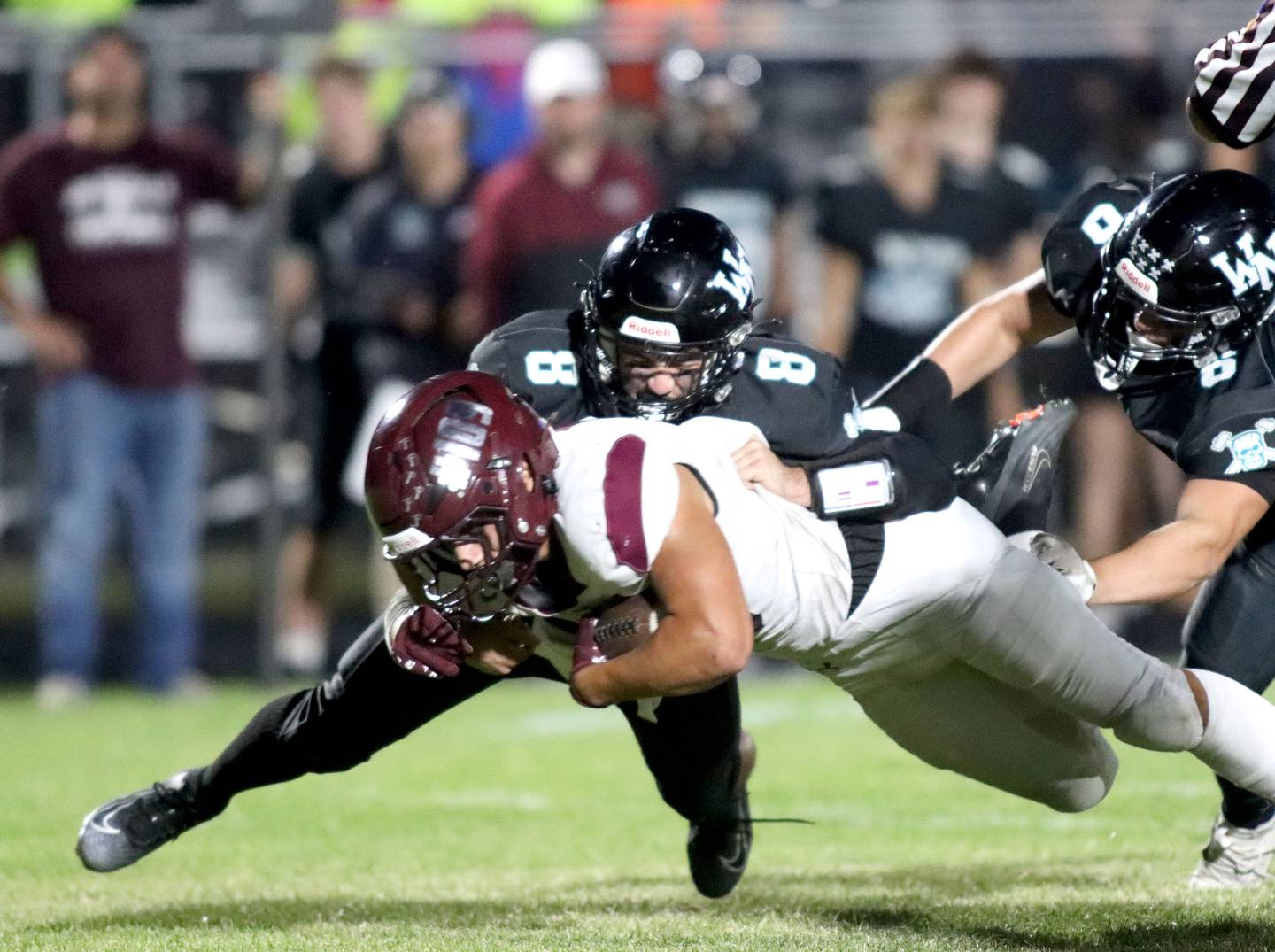 Marengo’s Gavin Baros lunges for extra yardage as he is hit by Woodstock North’s Michael Pintor in varsity football at Rod Poppe Field on the campus of Marengo High School in Marengo on Friday, Sept. 12, 2025.