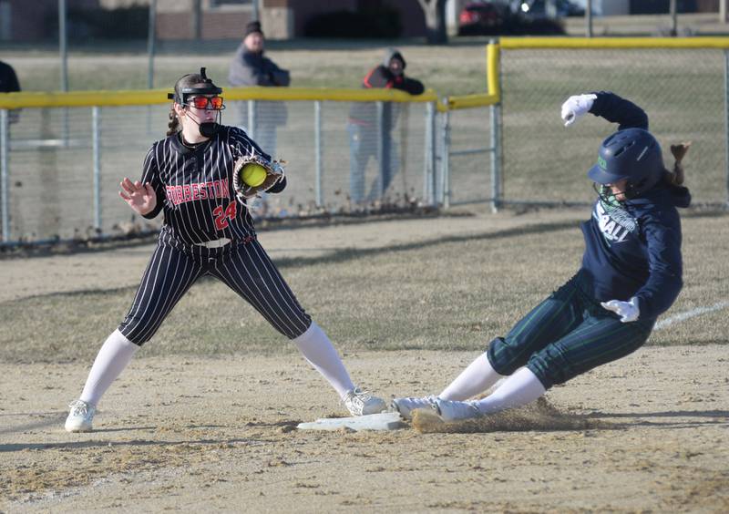 Forreston's Alice Kobler looks to tag a River Ridge/Scales Mound player as she slides safely into third ahead of the throw on Monday, March 24, 2025 in Forreston.