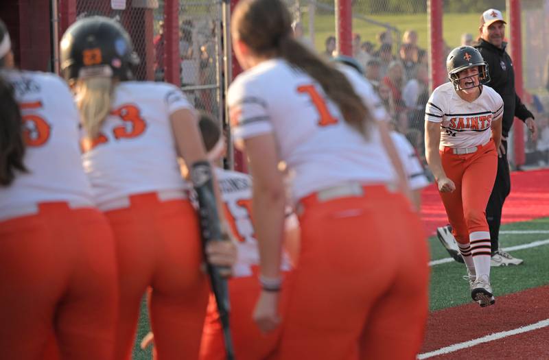 St. Charles East’s Hayden Sujack yells as she approaches her teammates at home plate after hitting a home run against Barrington in an IHSA Class 4A supersectional softball game in Barrington on Monday, May 9, 2025.