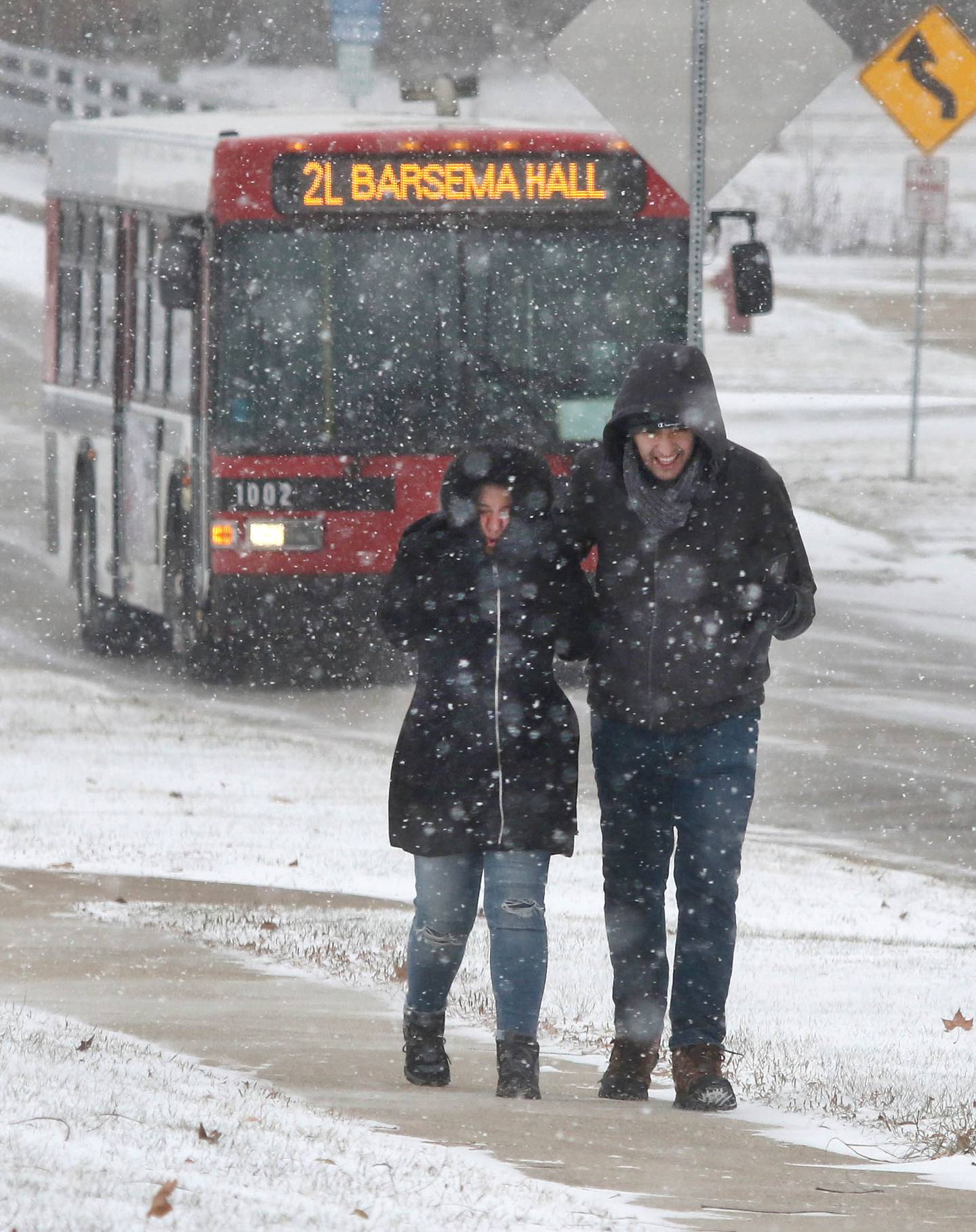 Khatereh Mohammadi (left) and Farid Ahmadpour, graduate students at Northern Illinois University from Iran, try to stay warm Thursday, Dec. 22, 2022, as the walk down Lucinda Avenue near campus in DeKalb. Snow, frigid temperatures and wind rolled into the area Thursday making getting around a challenge.