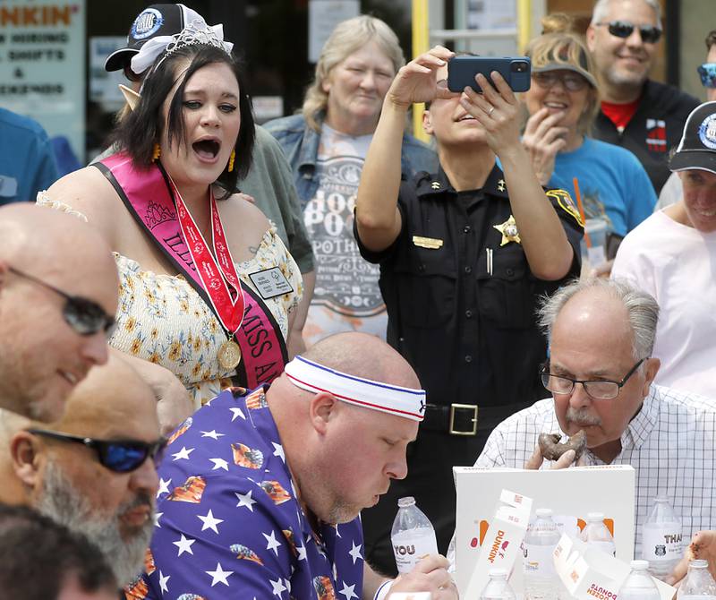 Special Olympian Catherine Barnes  cheers on donut eating contestants while they competing at Dunkin’ Donuts, in Huntley, during the Cop on a Rooftop fundraiser to raise awareness for Special Olympics Illinois and the Law Enforcement Torch Run to benefit Special Olympics on Friday, May 19. 2023.