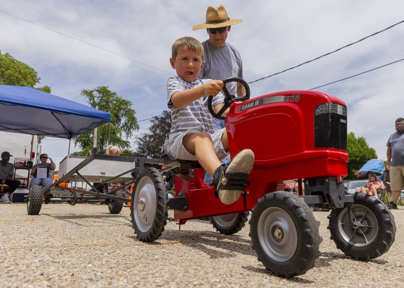 Kyson Grieff pushes to gain every inch during the second round of the kiddie tractor pull Saturday, June 15, 2024, during Beef and Ag Days at Soldiers and Sailors Park in Princeton.
