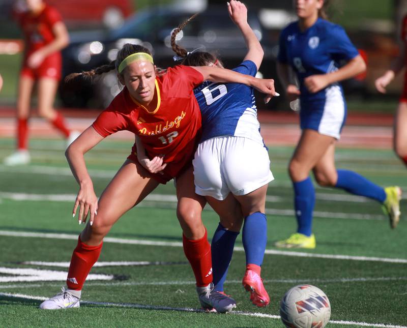 Batavia's Payton Haslett (left) and Geneva's Maggie Anderson get tangled up going after the ball during a Tri-Cities Soccer Night game on Tuesday, April 29, 2025 at St. Charles East.