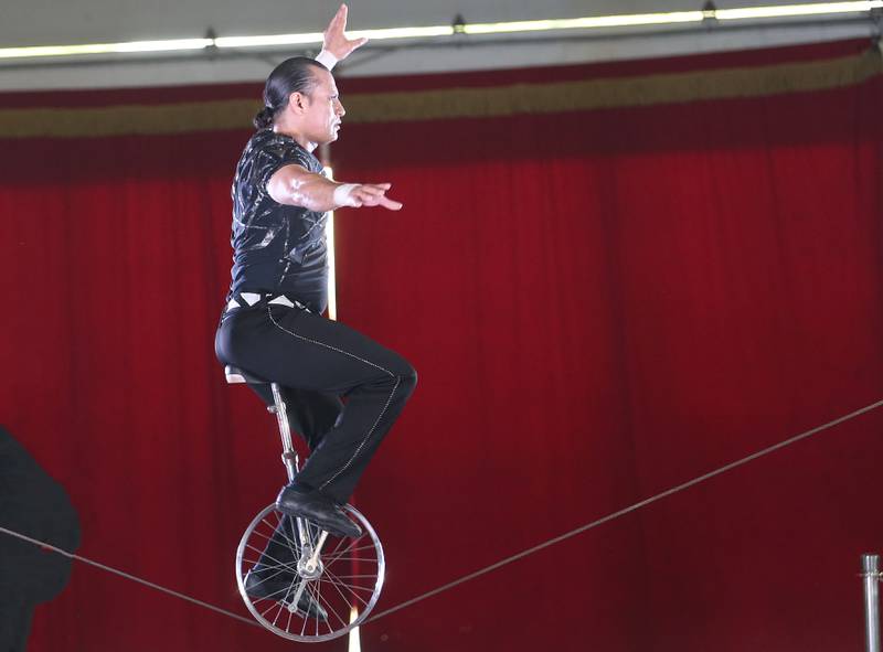 The Great Pages Circus Christian Ponce rides a unicycle during  while balancing on a slackwire on Monday, June 23, 2025 at the Bureau County Fairgrounds in Princeton. The Great Pages Circus is a family-friendly, traveling circus that blends traditional circus acts with a modern, energetic style.