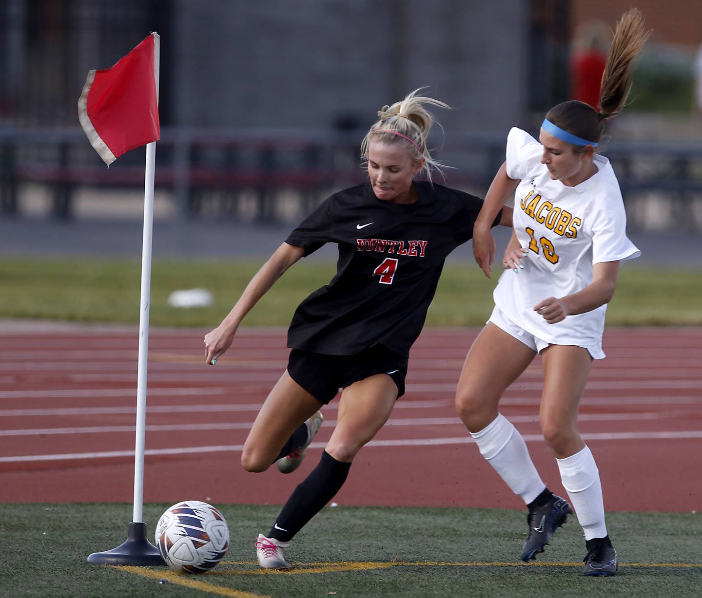 Huntley's Brooke Maxedon tries to keep the ball inbounds as she sis defended by Jacobs' Kayla Konkey during the IHSA Class 3A Huntley Girls Soccer Regional championship match on Friday, May 23, 2025, at Huntley High School.