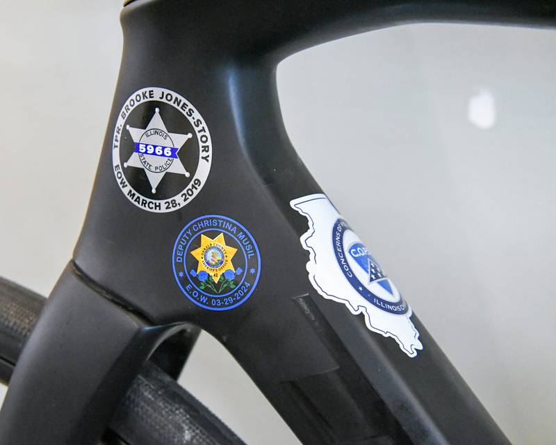 Stickers of police officers who lost their life while on the line of duty are placed on bikes of those who are being remembered during the Cycle Across Illinois on Saturday July 12, 2025, as members took a break for the night at Northern Illinois university in DeKalb.