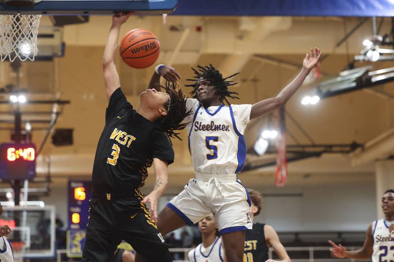 Joliet Central’s Deven Triplet blocks a shot by Joliet West’s Corey Nobles on Saturday, Jan. 27th, 2024 in Joliet.