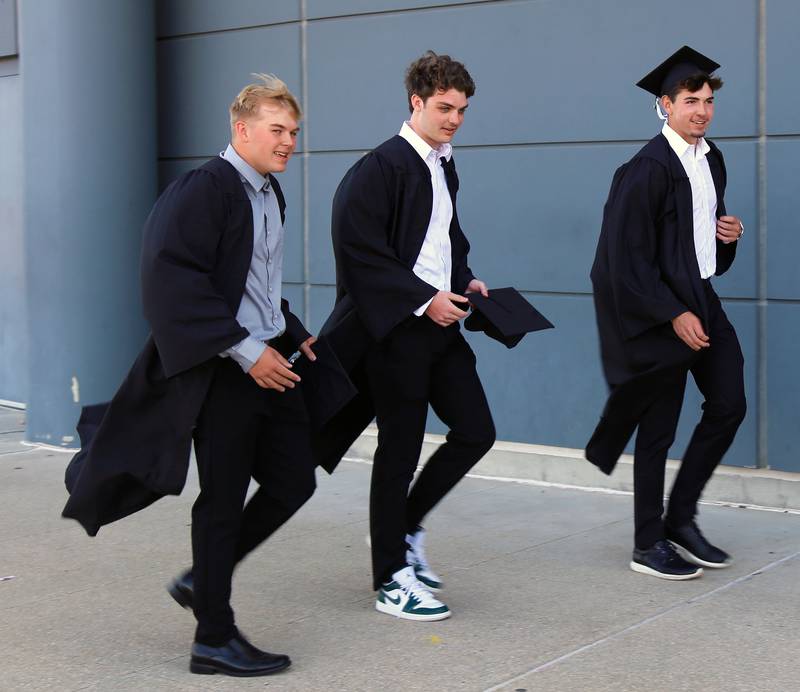 Brayden Seaton, Nicholas Corbett and Ryan Kuchar head into the NIU Convocation Center in DeKalb on Sunday, May 18, 2025.