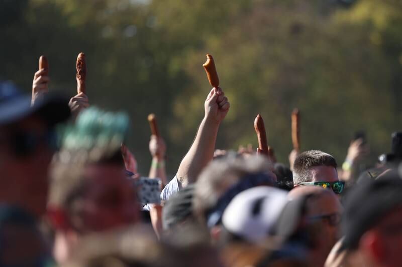 Fans hold up corn dogs during the Sincere Engineer performance at Riot Fest on Saturday, Sept. 21, 2024 in Chicago.