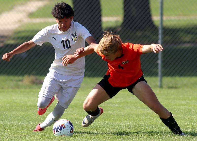 Crystal Lake Central’s Justin Moore, right, battles Harvard’s Bryan Gorostieta in varsity boys soccer at Crystal Lake Central High School in Crystal Lake on Saturday, Sept. 6, 2025.