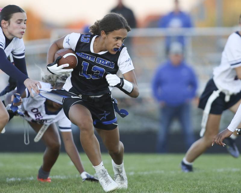 St. Charles North's Alexzandria Richardson (13) runs with the ball during Oswego East Regional Final flag football game between St. Charles North at Oswego East Thursday, Oct 9, 2025 in Oswego.