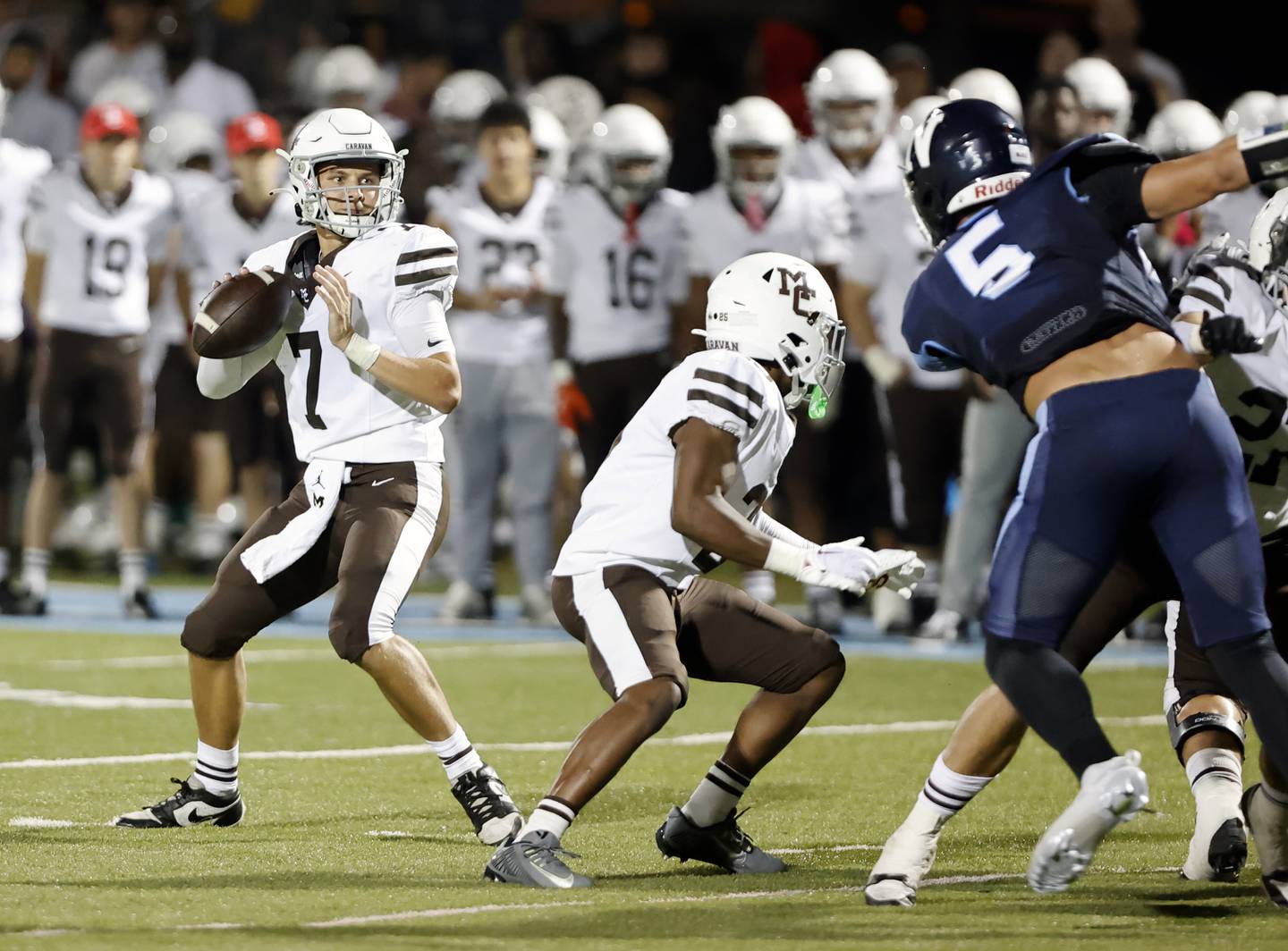 Mt. Carmel's Emmett Dowling (7) drops back to pass during the varsity football game between Mt. Carmel high school and Nazareth Academy on Friday, Sept. 12, 2025 in La Grange Park, IL.
