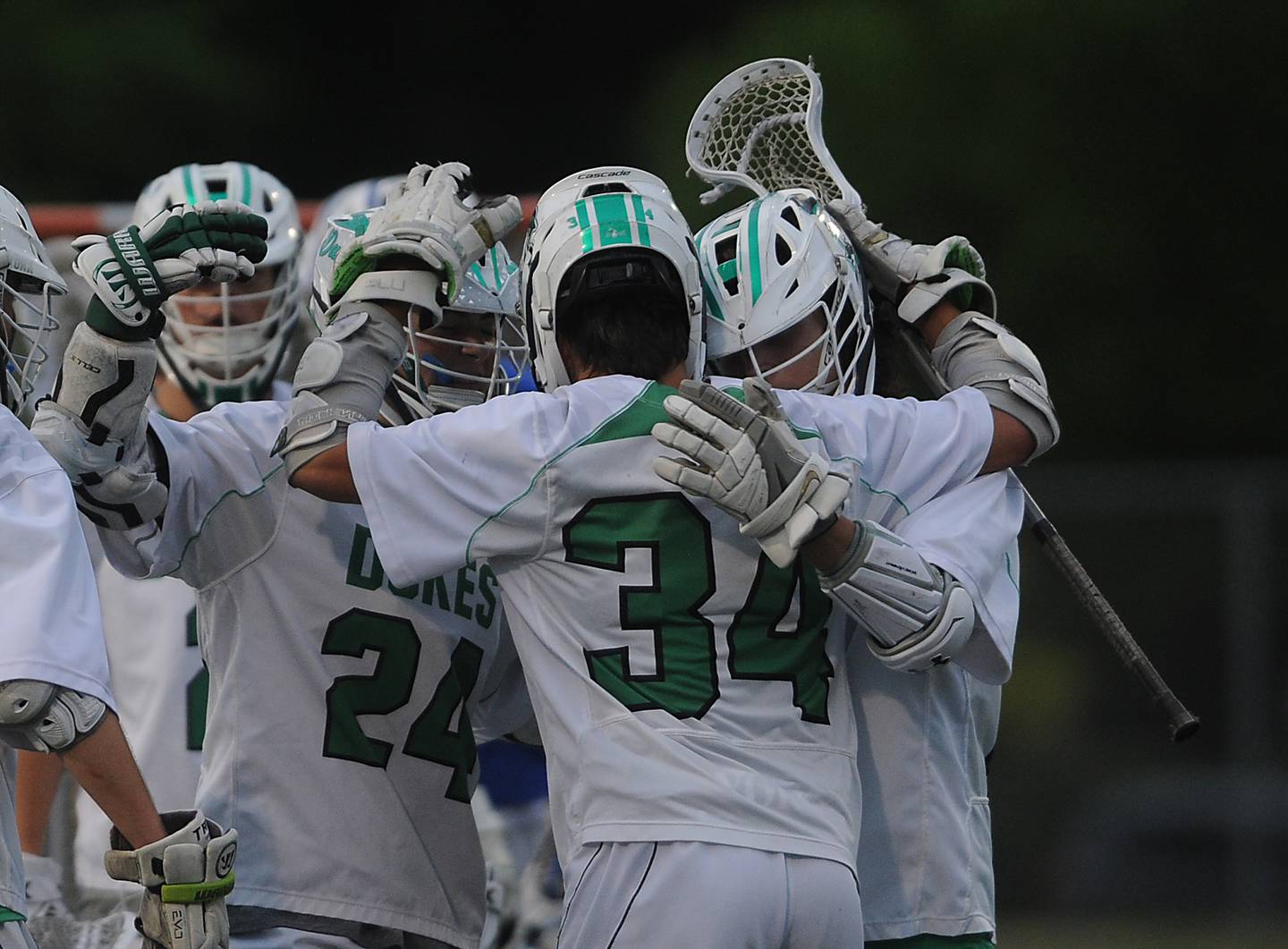 York's Charlie Toreja celebrates his second goal with his teammates in the first period at the boys lacrosse state semifinals at Robert Morris University football field in Arlington Heights on Thursday