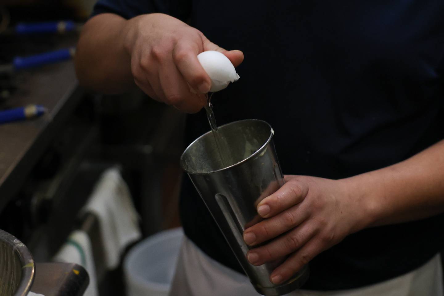 Arnold Tecaxco prepares scrabbled eggs for an order at Tasty Waffle in Romeoville.