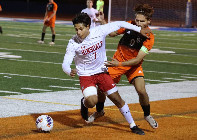 Hinsdale Central's Enzo Cinque tries to hold off Hersey's Ray Reyes Friday, Nov. 8, 2024, during their Class 3A state semifinal game at Hoffman Estates High School.