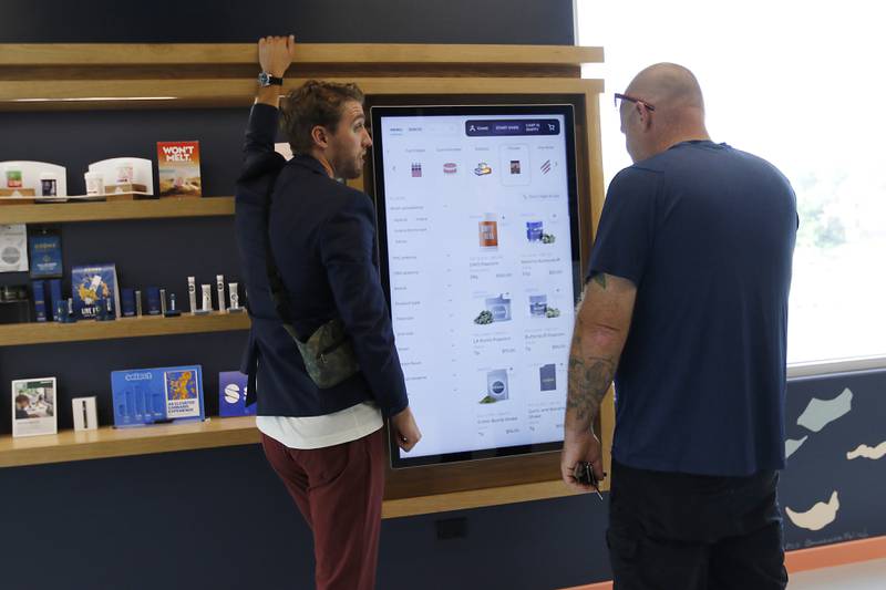 Smokehouse General Manager Zach Edgerton helps a customer at Illinois’ first dispensary located right on the water in Fox Lake on Friday, July 25, 2024. The dispensary located at 44 U.S. Route 12, features boat slips so customers on the Fox River and Chain o' Lakes can boat right up to the dispensary.