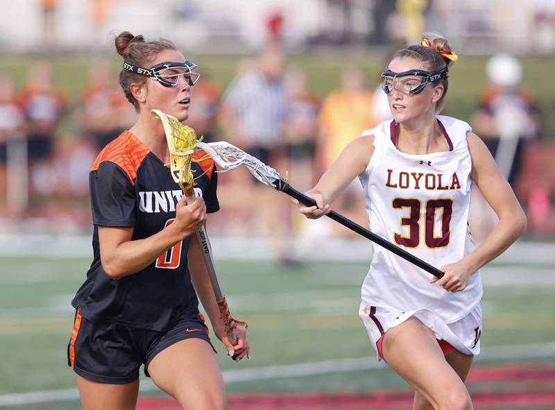 Crystal Lake Central Coop's Fiona Lemke (9) looks for an outlet during the lacrosse state semi-final match between Crystal Lake Central and Loyola Academy on Thursday, June 5, 2025 in Hinsdale.