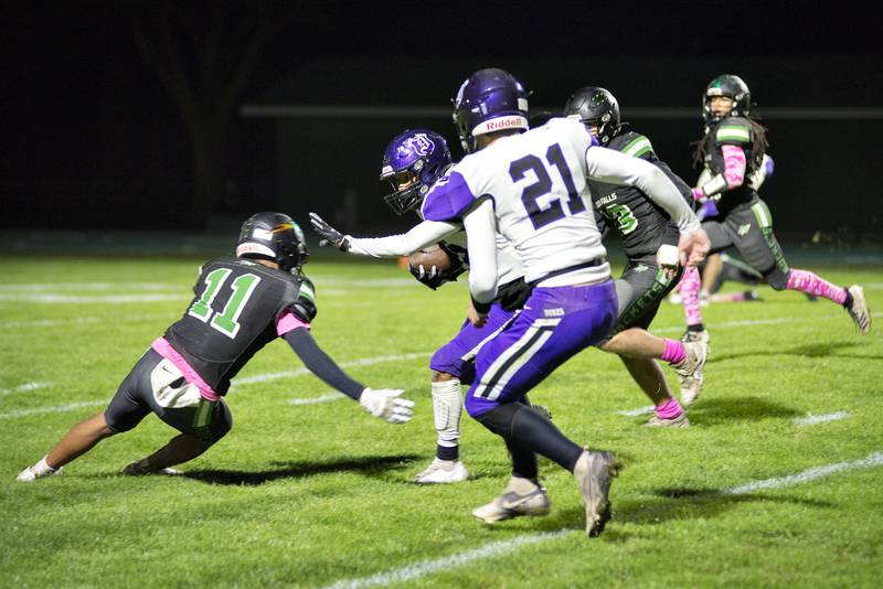 Dixon's Zavion avoids a tackle Friday Oct. 22, 2021 against Rock Falls on his way to a TD.