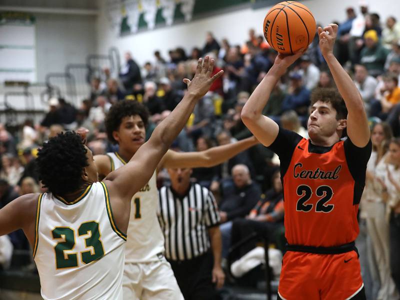 Crystal Lake Central's Johnny Geisser (right) shoots the ball over Crystal Lake South's David Mcfadden (left) during an IHSA Class 3A Crystal Lake South Regional boys basketball semifinal game on Wednesday, February, 25, 2026, at Crystal Lake South High School.