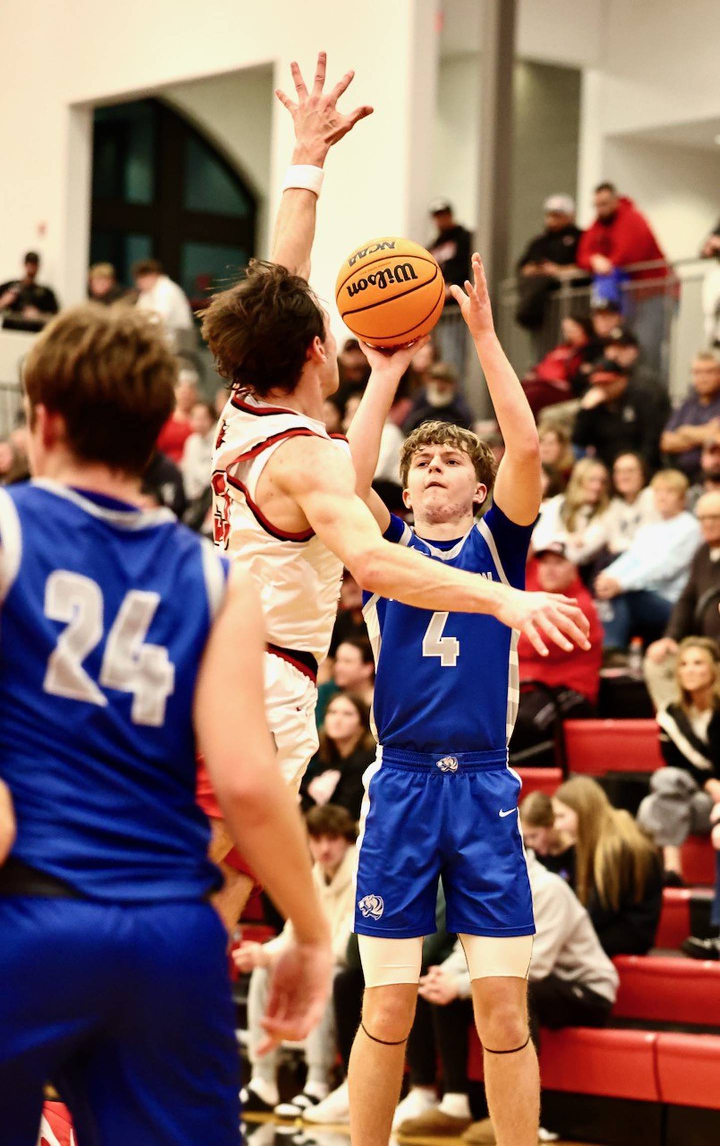 Princeton's Julian Mucha fires over Hall's Braden Curran in Friday's Three Rivers game in Spring Valley. The PHS freshmen led the Tigers with 18 points, all on 3-pointers. Hall won 57-51.