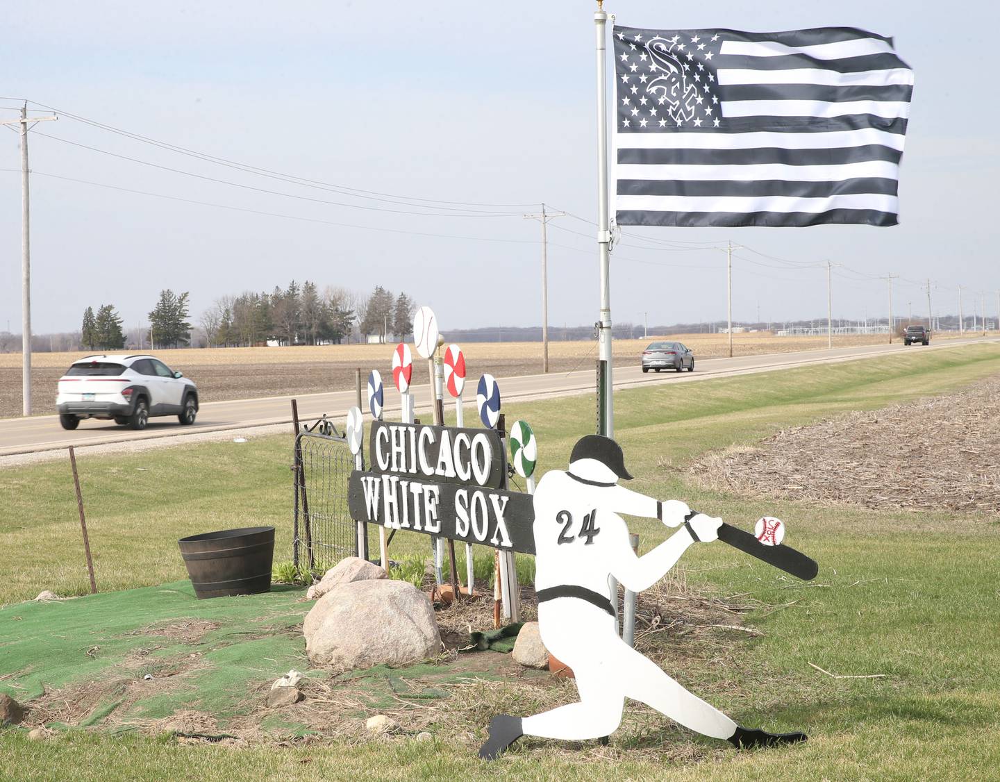 A Chicago White Sox display with pinwheels and baseball players can be seen near the Osage Curves on Wednesday, March 25, 2026 in Utica. Chalus and his family created and painted the wooden display about 15 years ago.