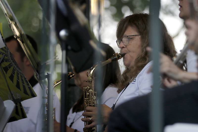 Debbie Schweihs plays the saxophone during a performance of the Woodstock City Band  on Wednesday, July 24, 2024, in the historic Woodstock Square. The band that is in its 140th season, performed their Galloping through the Gallery concert for the crowd.