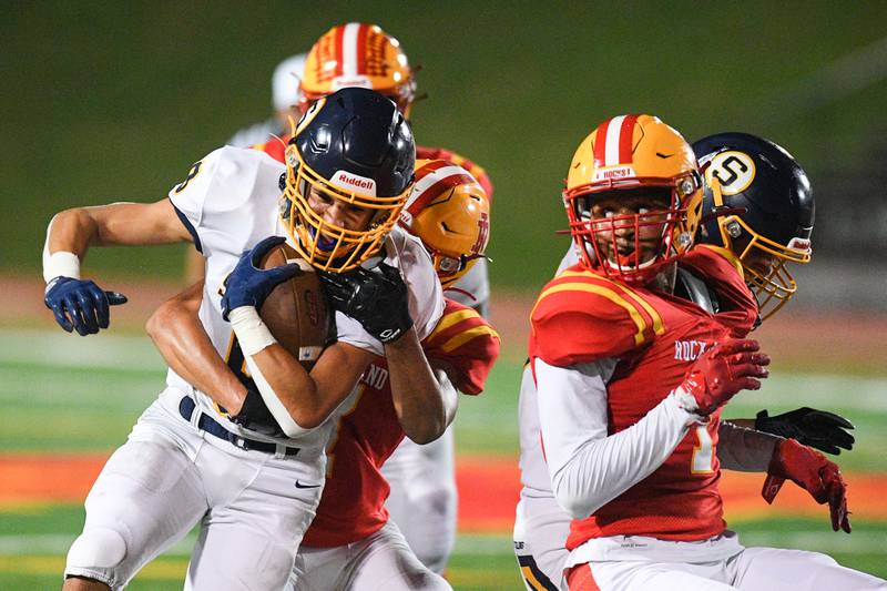 A Rock Island defender takes down Sterling's AJ Kested (9) during their game at Almquist Field Friday, Oct. 8, 2021, in Rock Island.