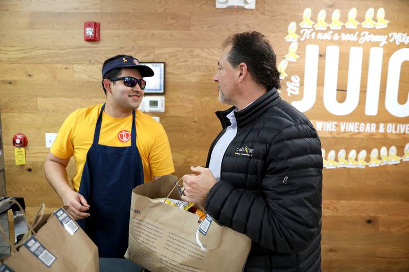 Urbano Hernandez (left), general manager of the Jersey Mike’s Subs in Geneva, chats with Tom Sutter, co-founder of Cal’s Angels and Cal’s dad, on Wednesday, March 26, 2025 during Jersey Mike’s Day of Giving. Jersey Mike’s owners and operators throughout Illinois donated every single dollar that came in that day to Cal’s Angels Pediatric Cancer Foundation, which is based in St. Charles.