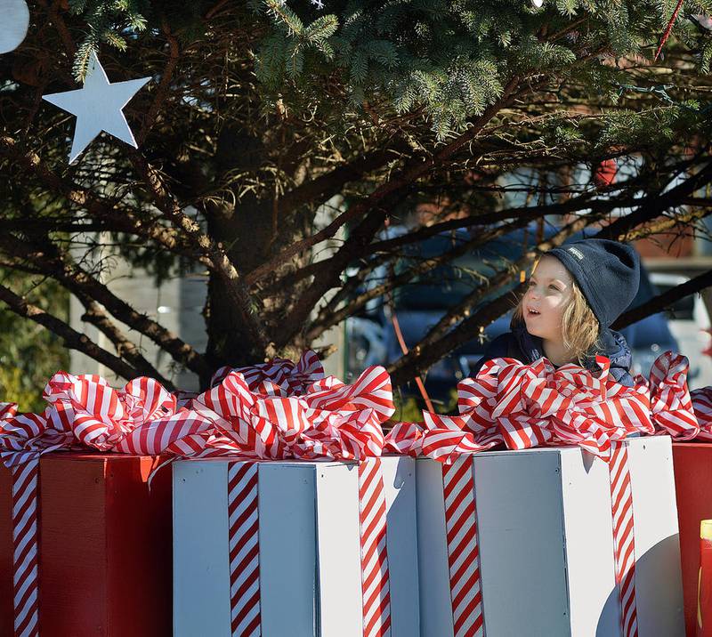 Sawyer Tiberi appears to pop out of a gift box Saturday while exploring under the Chris Kringle Market Christmas Tree on the Jordan block in Ottawa.