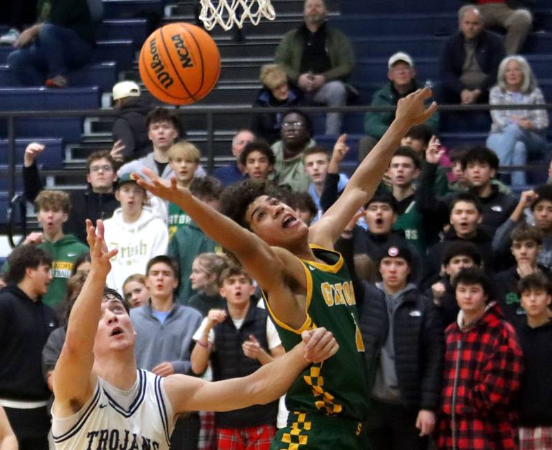Cary-Grove’s Adam Bauer, left, battles Crystal Lake South’s Noah Cook for the ball in varsity boys basketball on Wednesday, Dec. 3, 2025, at Cary-Grove High School in Cary.