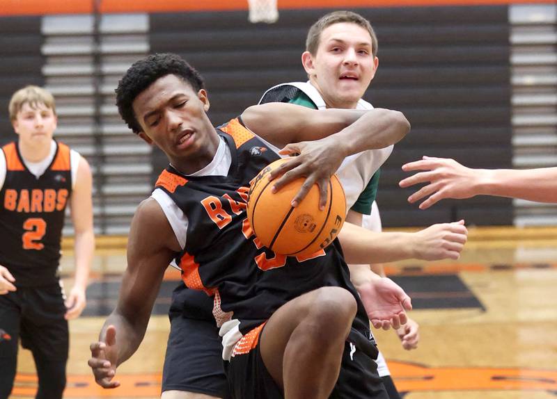 DeKalb’s Justin O'Neal pulls down a rebound during their summer game against Elk Grove Tuesday, June 18, 2024, at DeKalb High School.